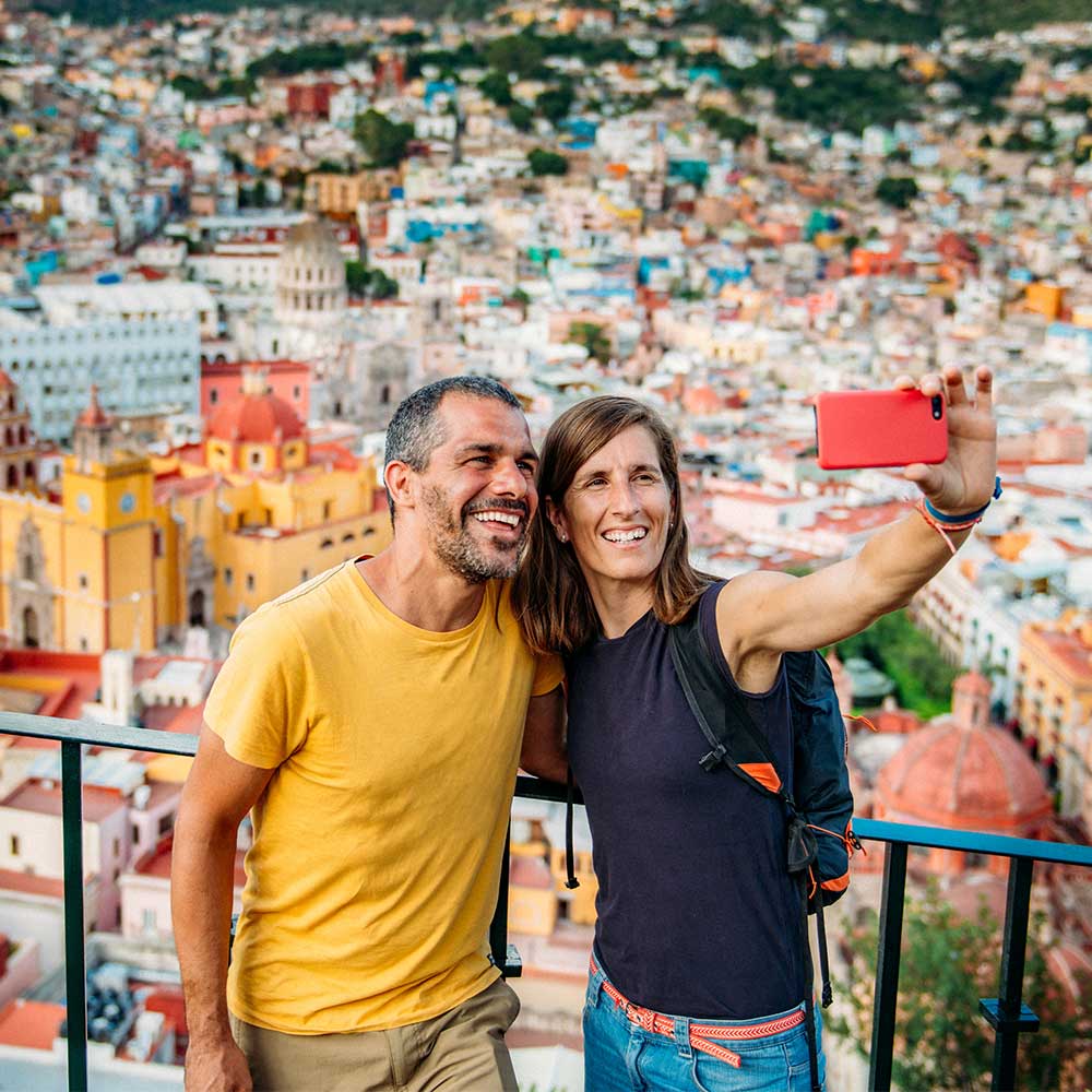 couple taking selfie city view