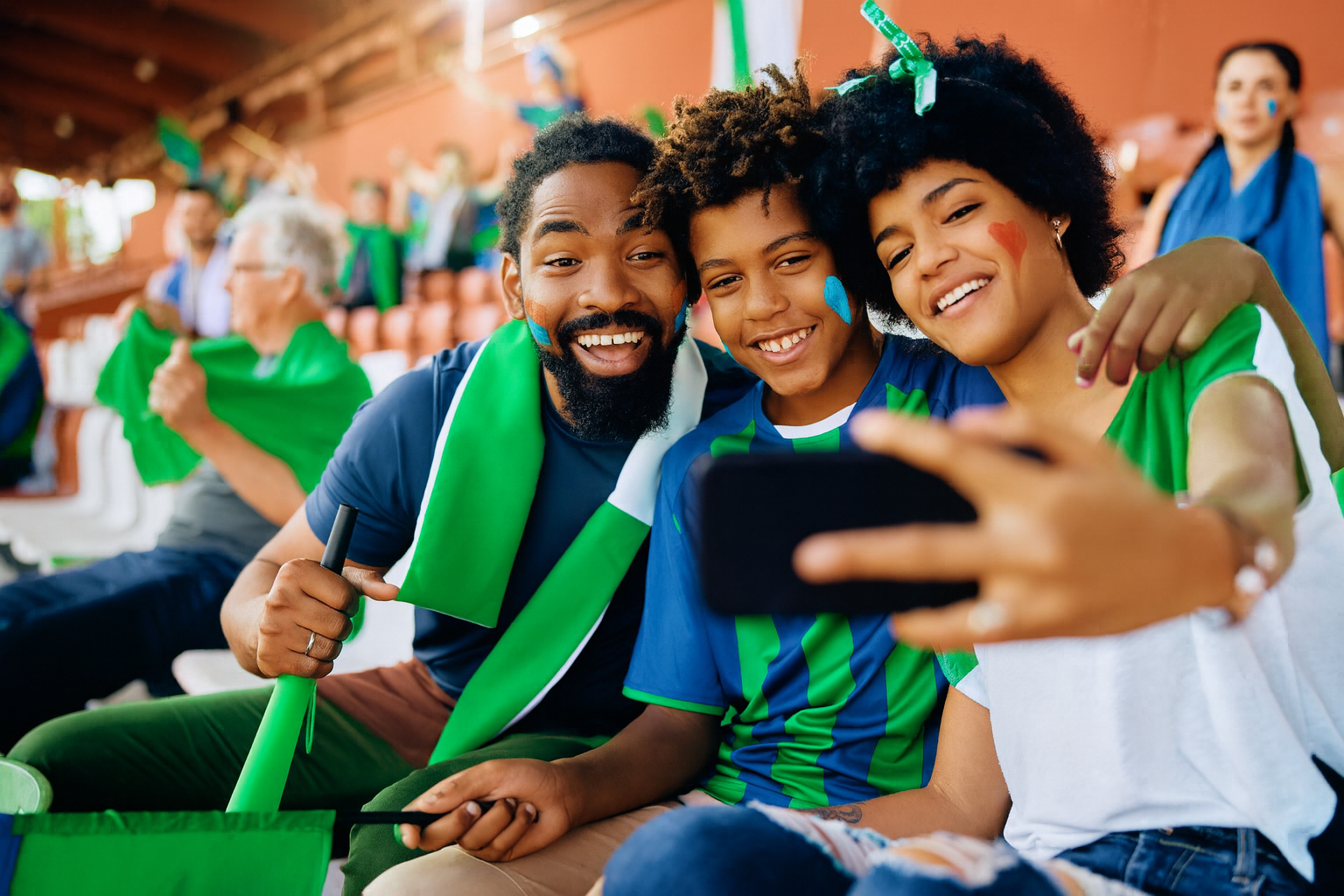 family taking a selfie at a sports game
