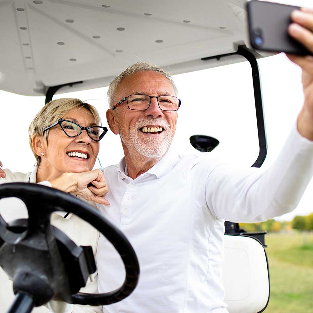 couple taking a selfie on golf cart