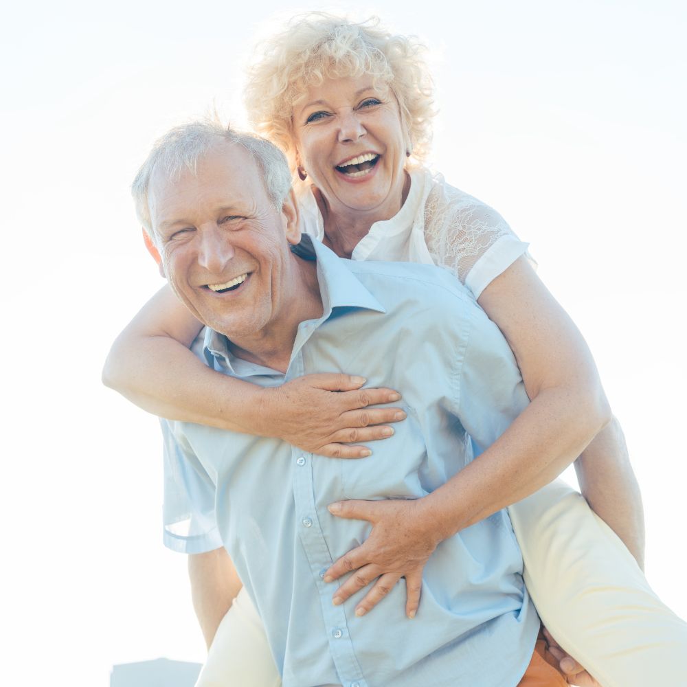 older couple piggy back ride