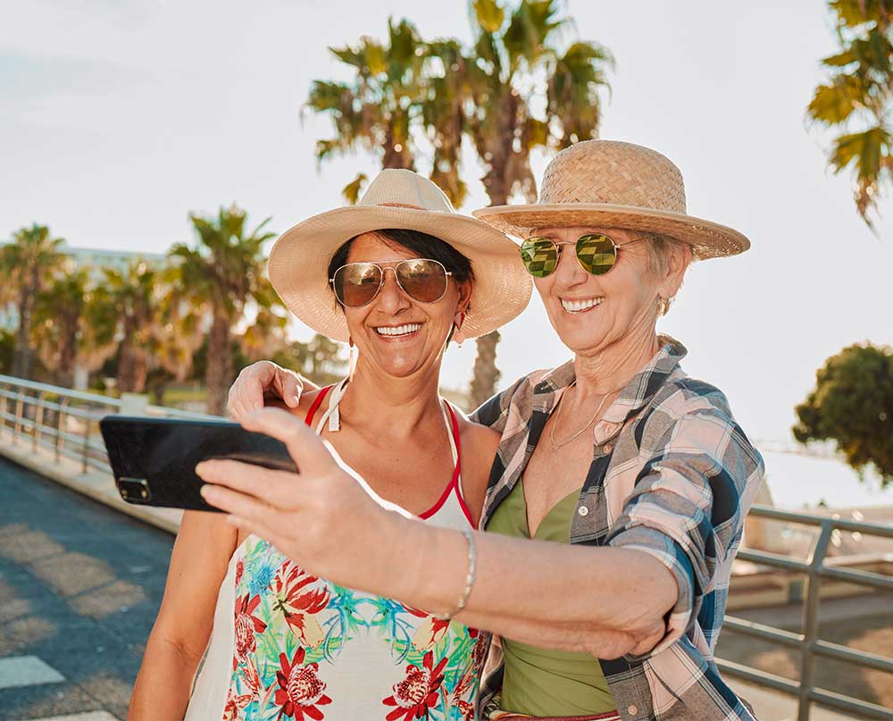 older women travelers taking selfie